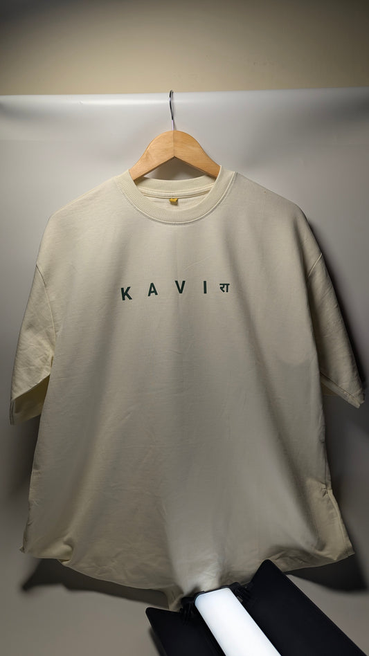 Beige t-shirt with 'KAVI' branding on a hanger.